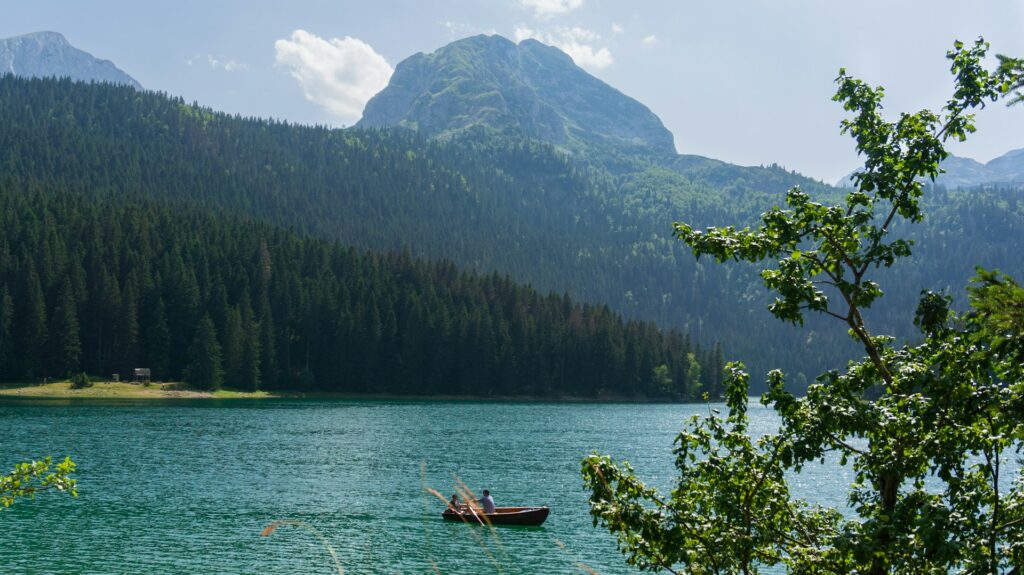 Montenegro, lake and mountains, boat, backpacking