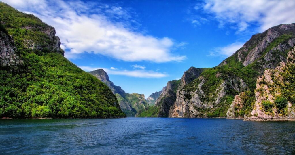 one week in Albania, mountains, lake, body of water, blue sky