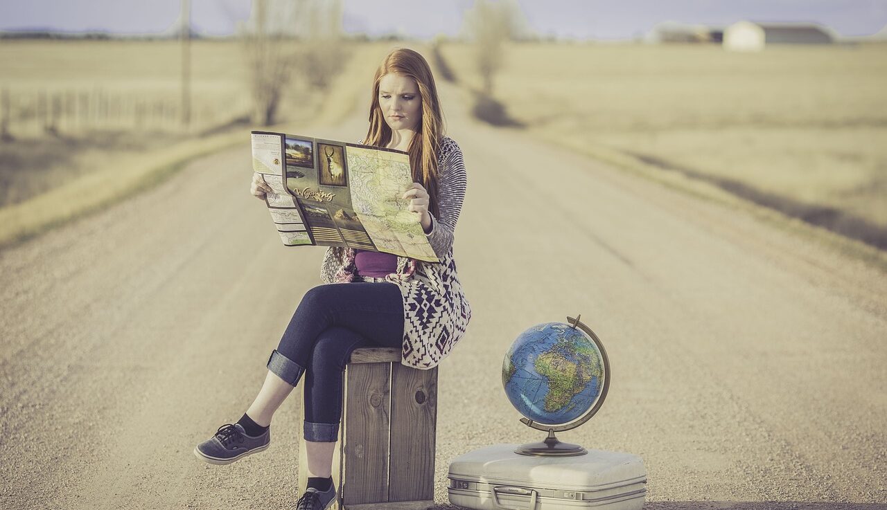 cultural travel tours, woman on a suitcase, globe, map, road