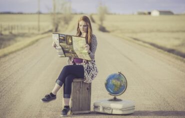 cultural travel tours, woman on a suitcase, globe, map, road