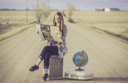 cultural travel tours, woman on a suitcase, globe, map, road