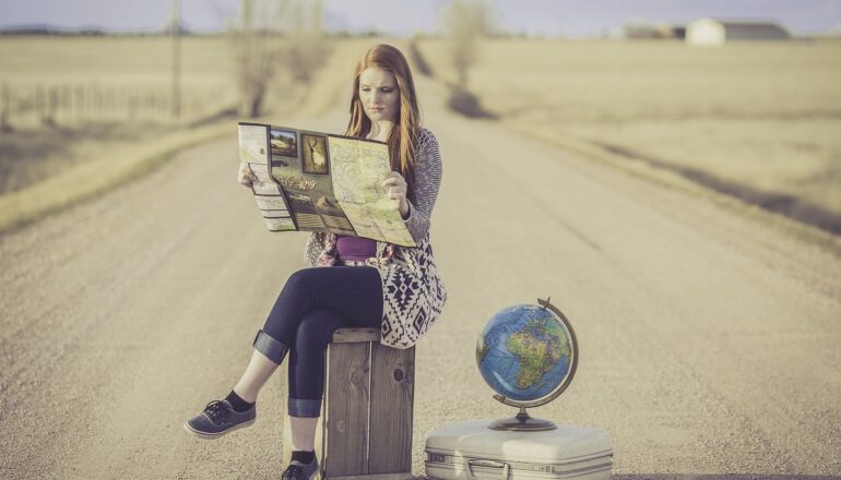 cultural travel tours, woman on a suitcase, globe, map, road