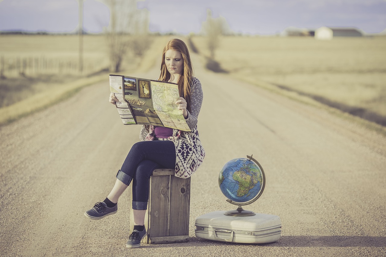 cultural travel tours, woman on a suitcase, globe, map, road